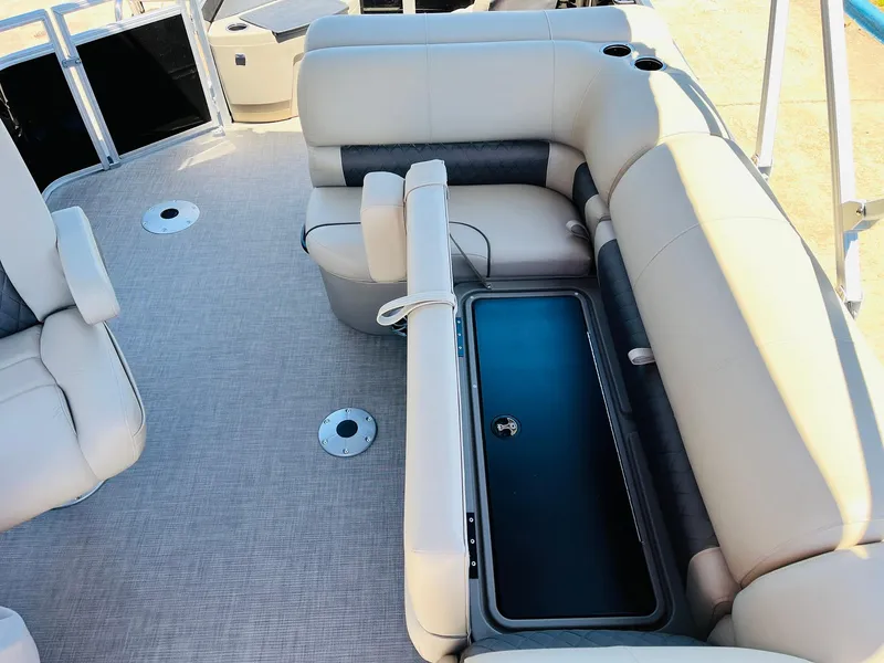 Slide: The Image of 2024 Sun Tracker SportFish 20 DLX boat interior with cushioned seating and storage compartment. - 26