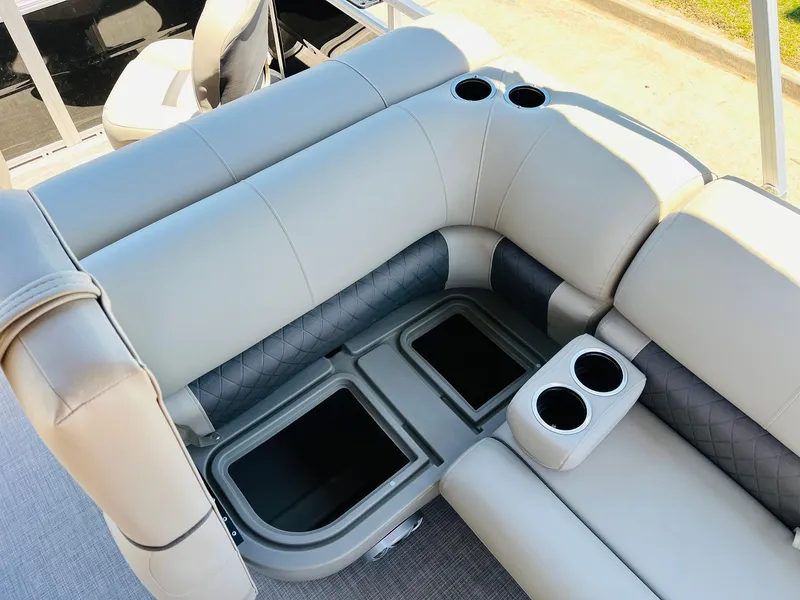 Slide: The Image of 2024 Sun Tracker SportFish 20 DLX boat seating with storage and cup holders. - 28