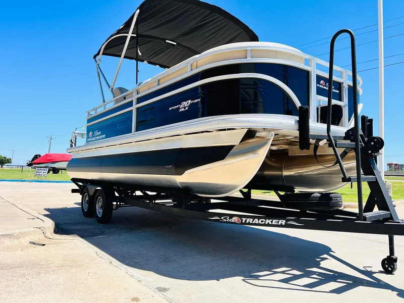 Slide: The Image of 2024 Sun Tracker SportFish 20 DLX pontoon boat on trailer, sunny day. - 3