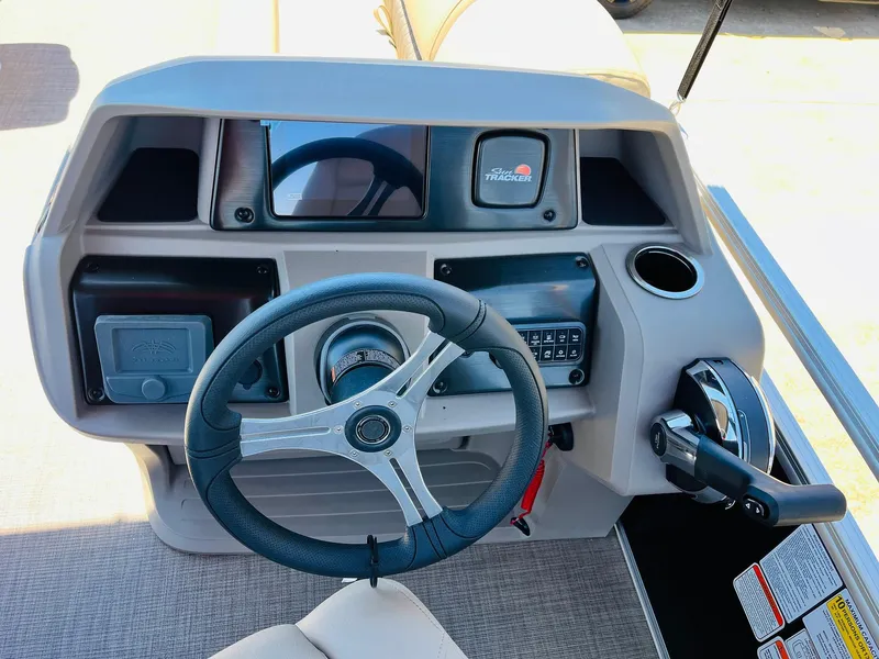Slide: The Image of 2024 Sun Tracker SportFish 20 DLX dashboard with steering wheel and controls. - 31