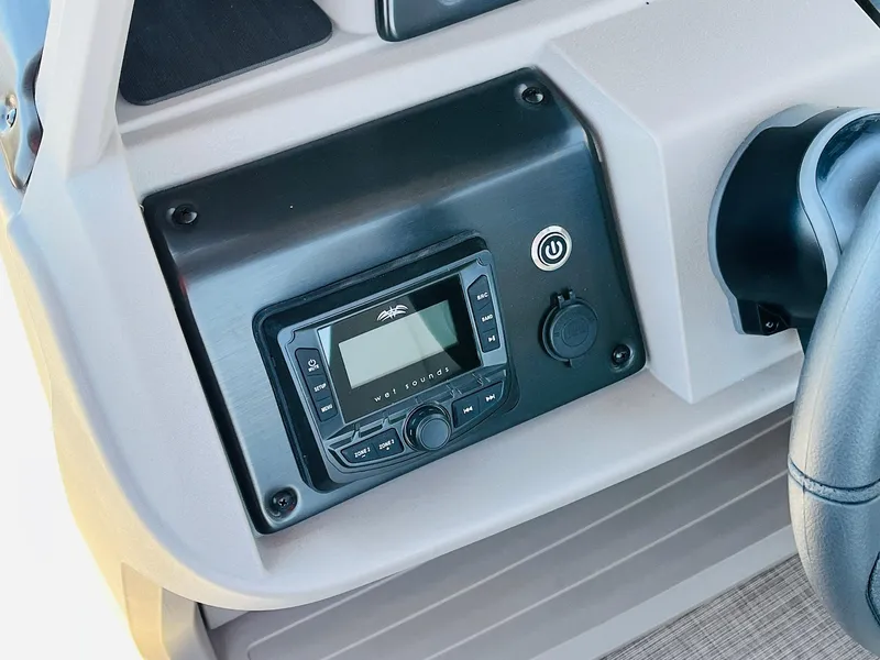 Slide: The Image of 2024 Sun Tracker SportFish 20 DLX dashboard with control panel and power button. - 32