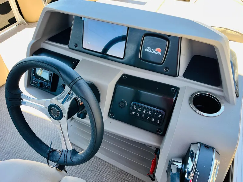Slide: The Image of 2024 Sun Tracker SportFish 20 DLX dashboard with steering wheel and controls. - 33