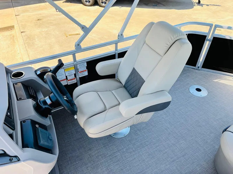 Slide: The Image of 2024 Sun Tracker SportFish 20 DLX boat interior with captain's chair and steering wheel. - 35