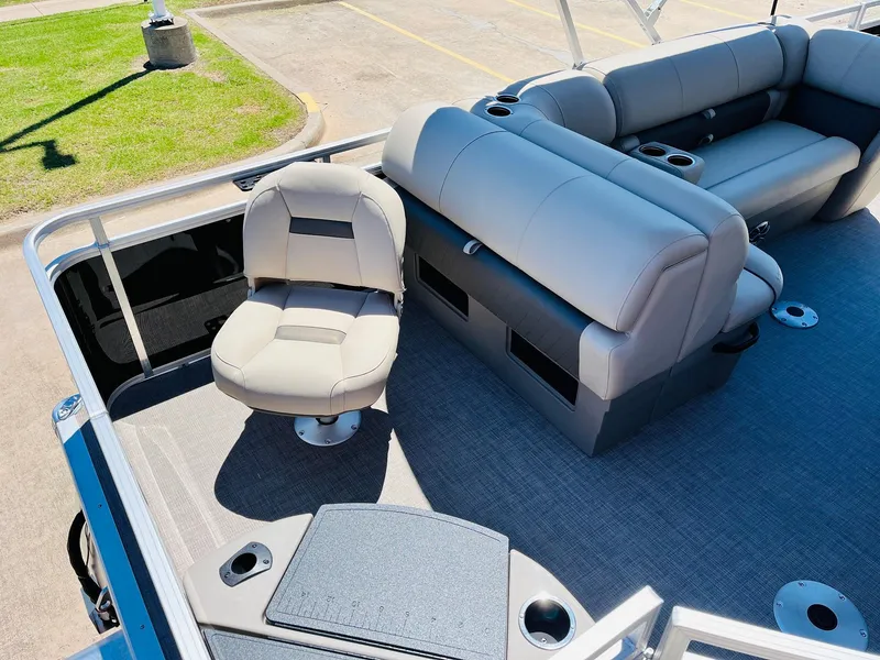 Slide: The Image of 2024 Sun Tracker SportFish 20 DLX pontoon boat interior with seating and cup holders. - 38