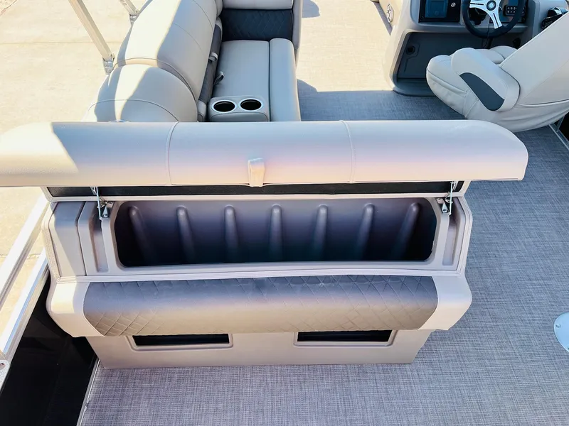 Slide: The Image of 2024 Sun Tracker SportFish 20 DLX boat interior with open storage compartment and seating. - 39