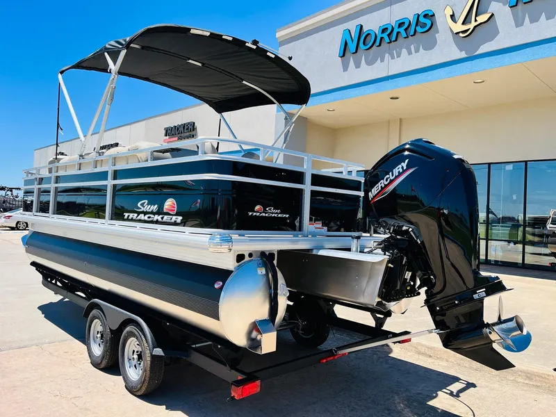 Slide: The Image of 2024 Sun Tracker SportFish 20 DLX pontoon boat with Mercury engine at dealership. - 7