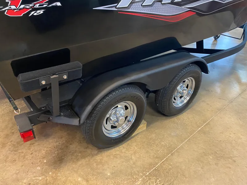 Slide: The Image of 2024 Tracker Targa V-18 Combo boat trailer with dual wheels on display. - 2