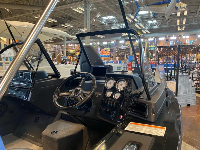 Slide: The Image of 2024 Tracker Targa V-18 Combo boat interior with steering wheel and dashboard controls. - 3