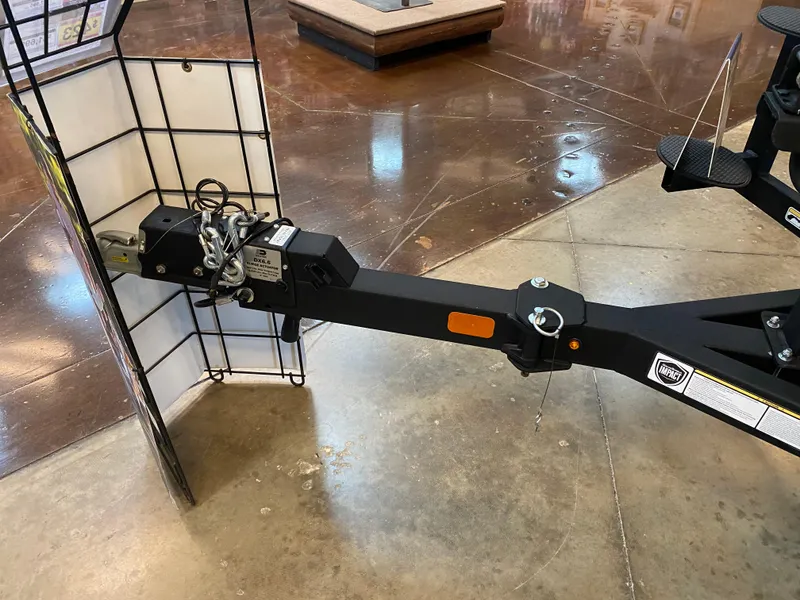 Slide: The Image of 2024 Tracker Targa V-18 Combo trailer hitch in showroom setting. - 7