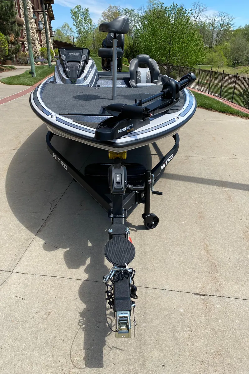 Slide: The Image of 2024 Nitro Z19 fishing boat parked on a concrete driveway. - 2