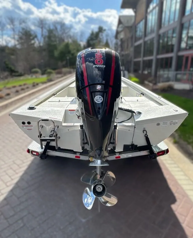 Slide: The Image of 2024 Ranger RB200 boat with an outboard motor, parked on a brick pathway. - 3