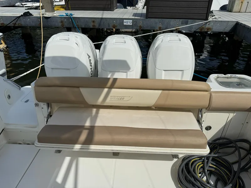 Slide: The Image of Boston Whaler 370 Outrage 2010 with triple outboard engines and cushioned seating. - 11