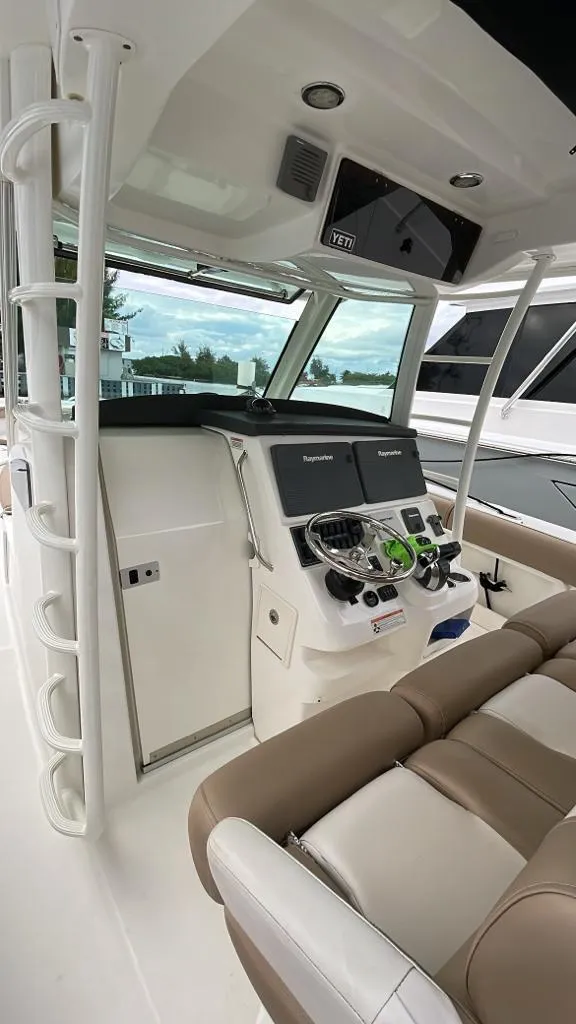 Slide: The Image of 2010 Boston Whaler 370 Outrage helm with modern controls and comfortable seating. - 6