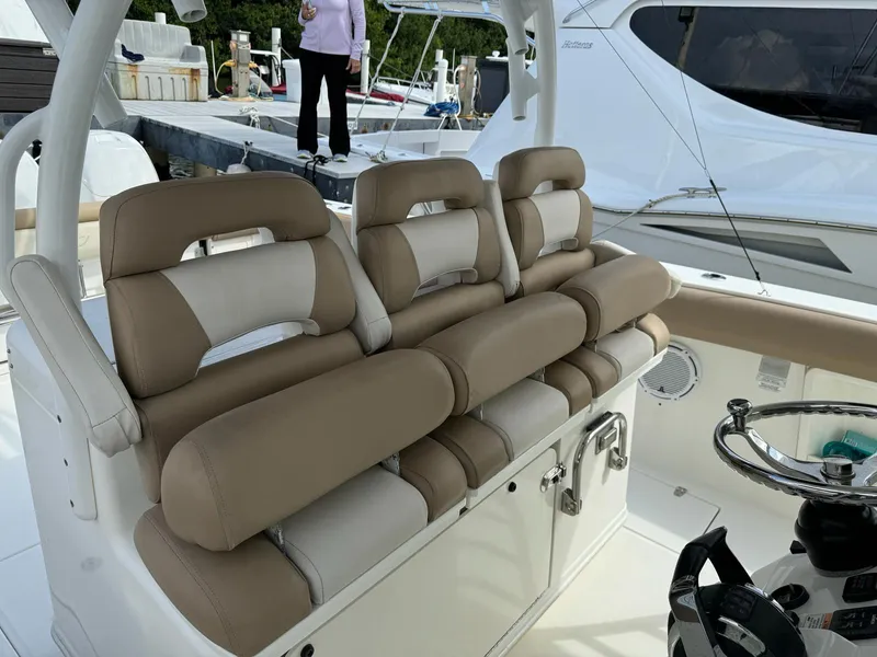 Slide: The Image of Boston Whaler 370 Outrage 2010 boat with beige seating and steering wheel. - 7