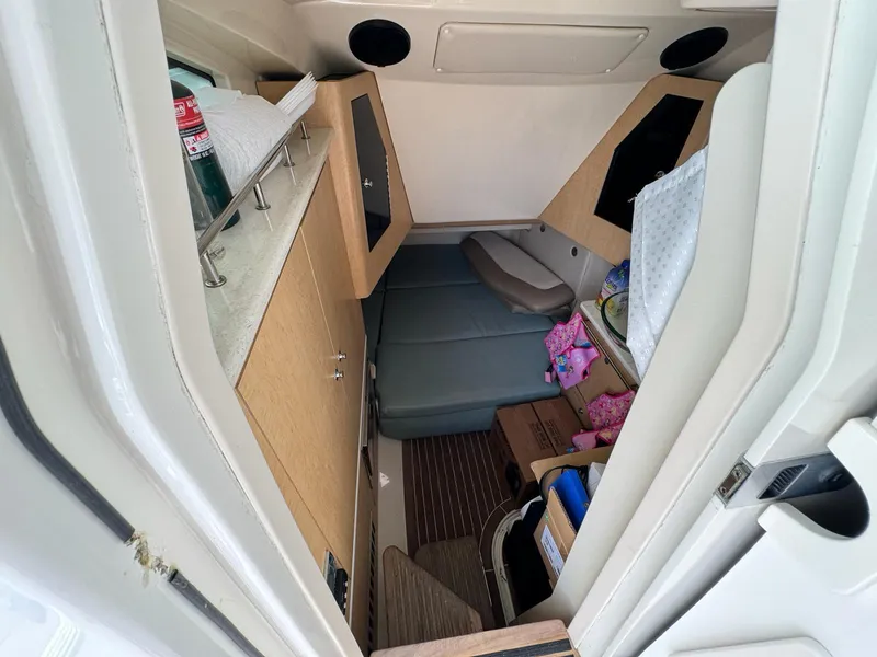 Slide: The Image of Interior cabin of a 2010 Boston Whaler 370 Outrage boat, featuring seating and storage. - 9