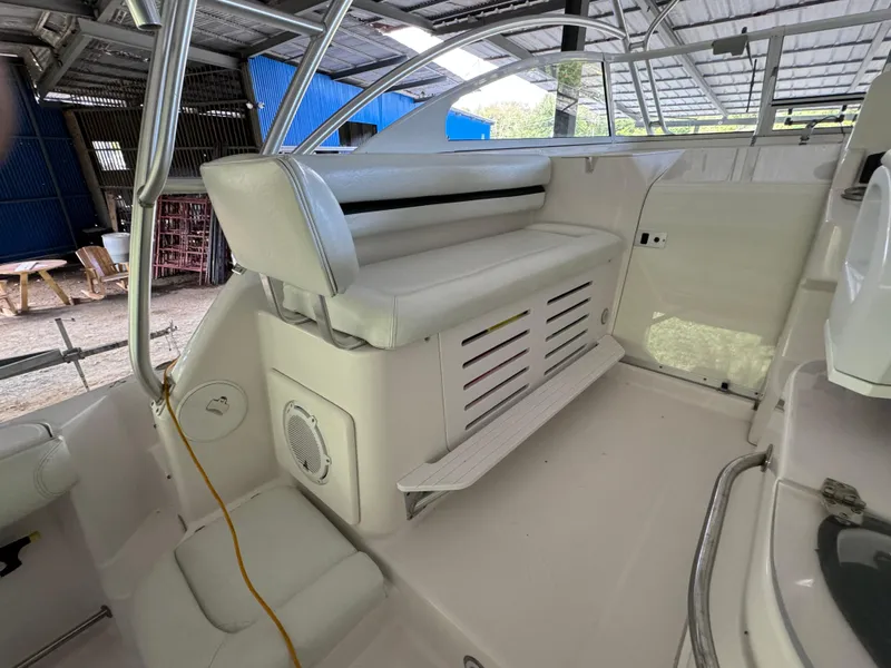 Slide: The Image of 2005 Pro-Line 32 Express boat interior with white seating and storage area. - 5