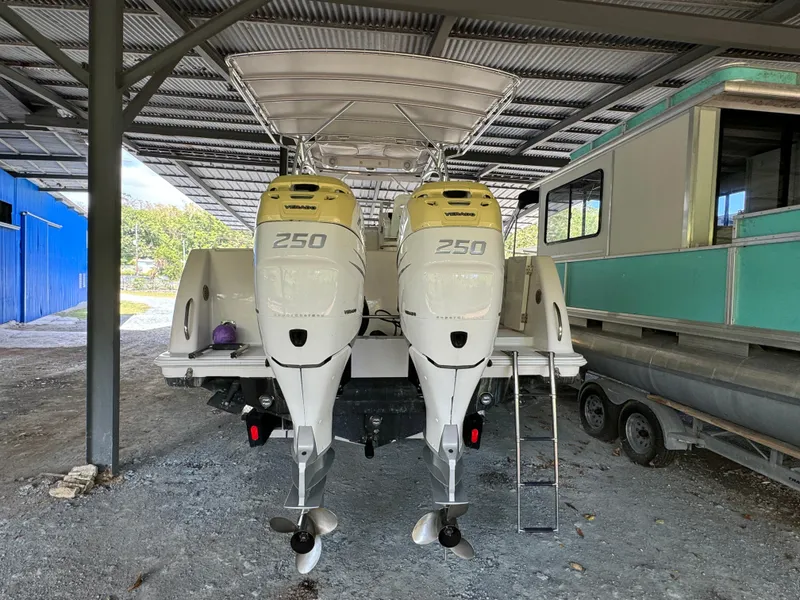 Slide: The Image of 2005 Pro-Line 32 Express boat with twin 250 horsepower engines in a covered storage area. - 7