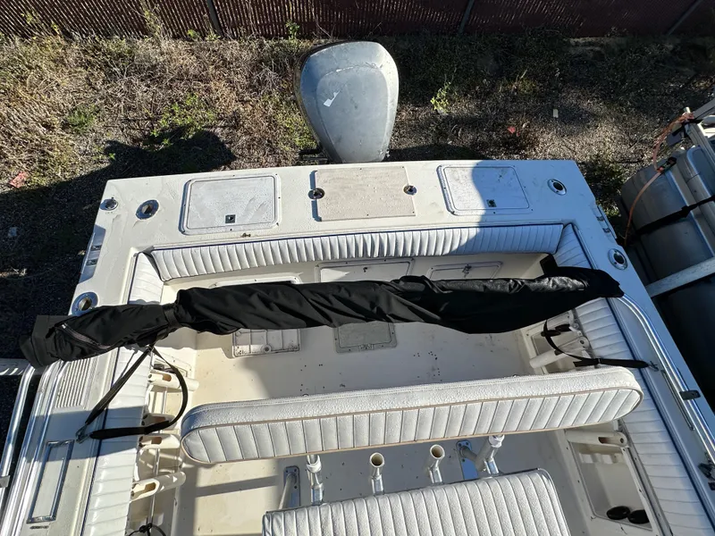 Slide: The Image of 1991 Pro-Line 210 boat interior with covered equipment and seating. - 10