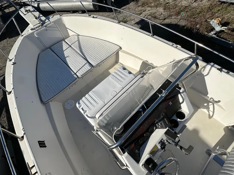 Slide: The Image of 1991 Pro-Line 210 boat interior with seating and steering console. - 11