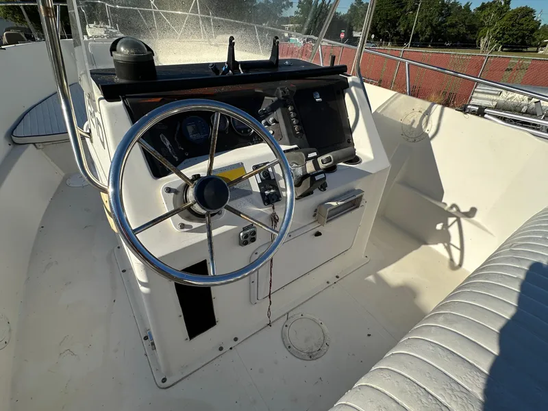 Slide: The Image of 1991 Pro-Line 210 boat helm with steering wheel and control panel. - 12