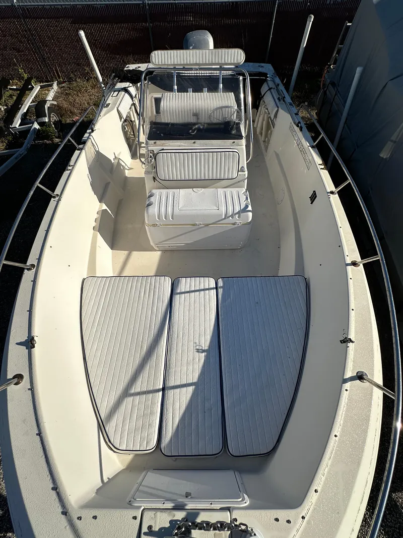 Slide: The Image of 1991 Pro-Line 210 boat with white seating and deck. - 13