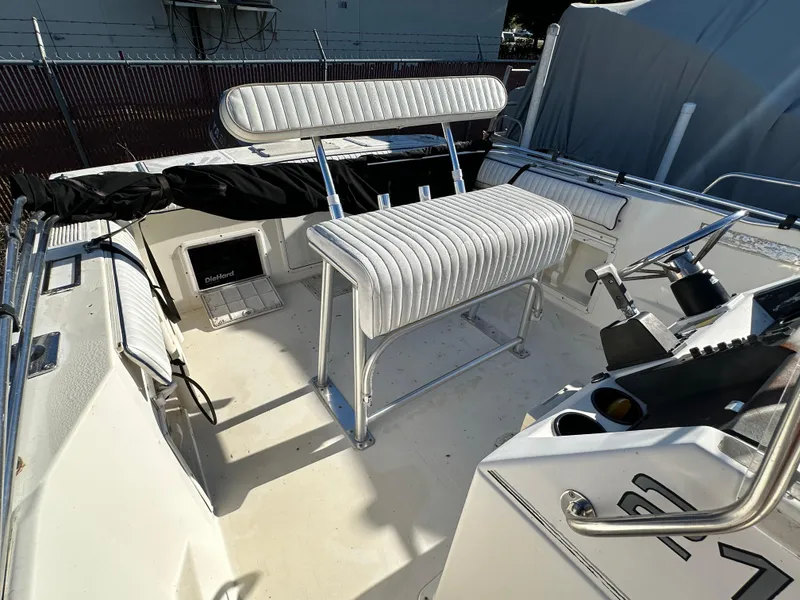 Slide: The Image of 1991 Pro-Line 210 boat interior with white seating and control console. - 14