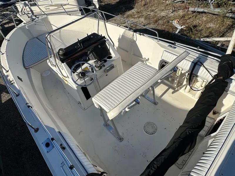 Slide: The Image of 1991 Pro-Line 210 boat interior with steering console and seating. - 6