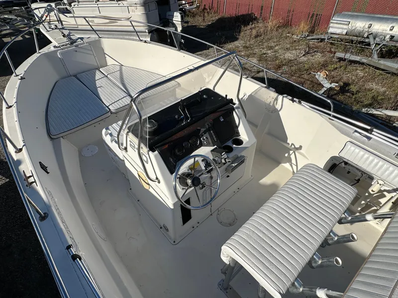 Slide: The Image of 1991 Pro-Line 210 boat interior with steering console and seating. - 7