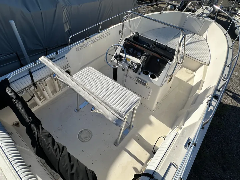 Slide: The Image of 1991 Pro-Line 210 boat interior with steering console and seating. - 8