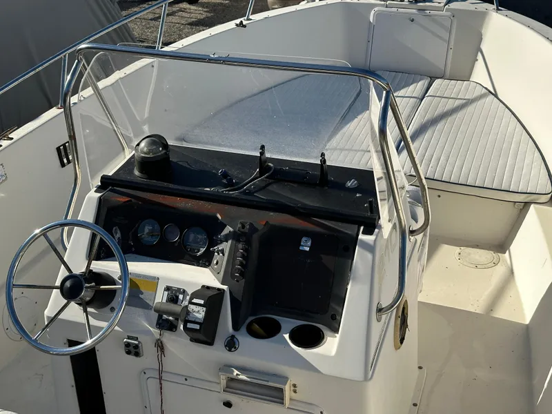 Slide: The Image of 1991 Pro-Line 210 boat cockpit with steering wheel and control panel. - 9