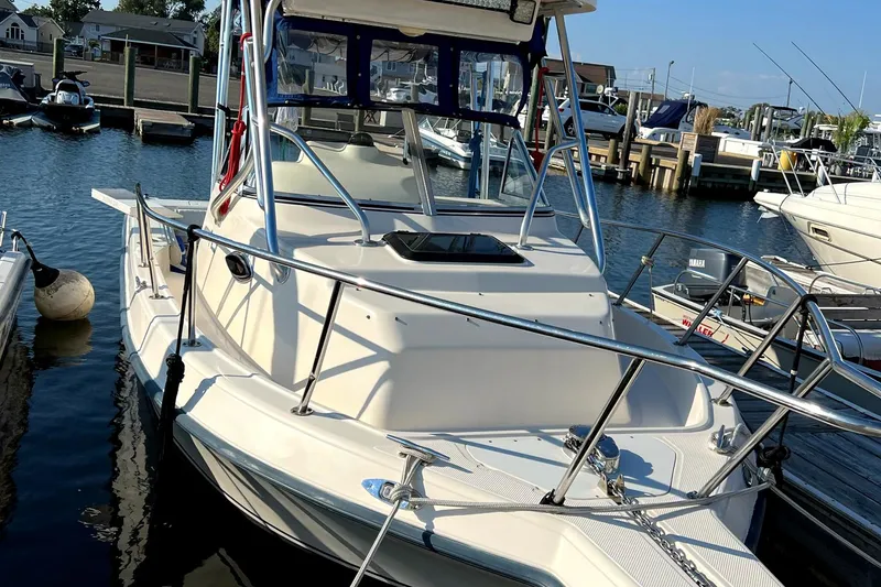 Slide: The Image of 2005 Key West 2300 WA boat docked at a marina. - 2