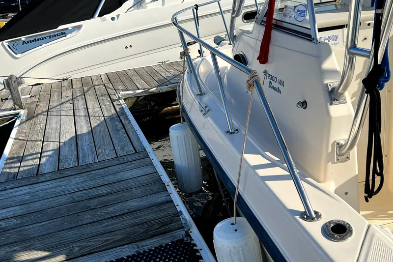 Slide: The Image of 2005 Key West 2300 WA boat docked at a marina. - 6