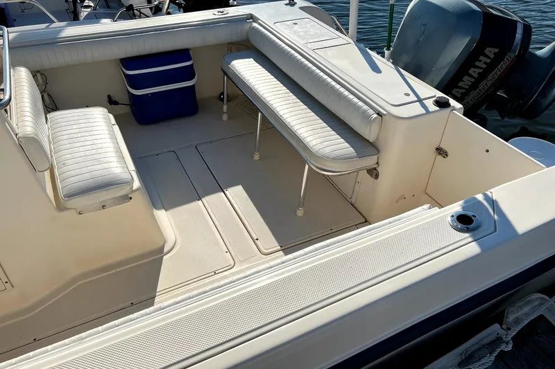 Slide: The Image of 2005 Key West 2300 WA boat interior with seating and Yamaha outboard motor. - 7