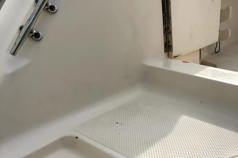 Slide: The Image of 2005 Key West 2300 WA boat interior, showing clean white deck and stainless steel fittings. - 8