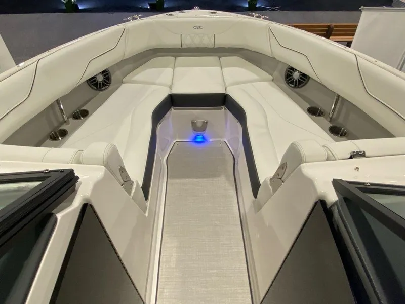 Slide: The Image of 2025 Regal LX4 boat interior with white seating, cup holders, and speakers. - 6