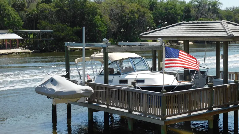 The Image of 2005 Legacy Yachts 28 Express docked with American flag. - 0