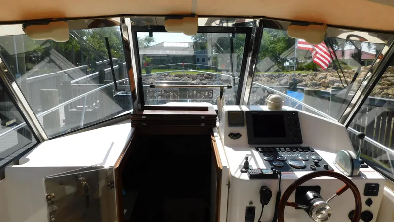 Slide: The Image of Interior helm of 2005 Legacy Yachts 28 Express with navigation equipment and steering wheel. - 10