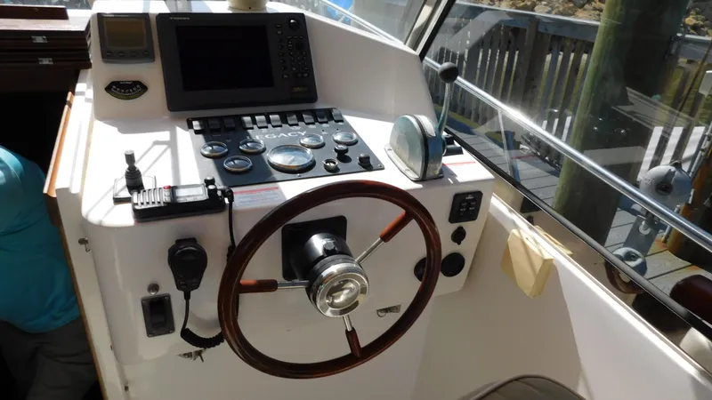 Slide: The Image of Helm station of 2005 Legacy Yachts 28 Express with steering wheel and navigation equipment. - 17