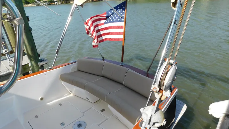 Slide: The Image of 2005 Legacy Yachts 28 Express boat with American flag on water. - 20