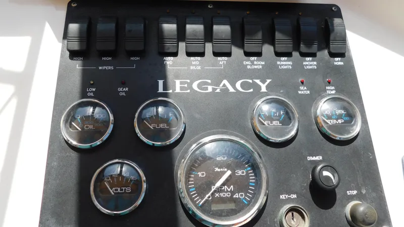 Slide: The Image of Control panel of a 2005 Legacy Yachts 28 Express boat with gauges and switches. - 21