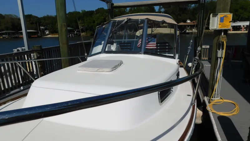 Slide: The Image of 2005 Legacy Yachts 28 Express docked, front view with American flag. - 3