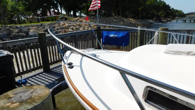 Slide: The Image of 2005 Legacy Yachts 28 Express docked, bow view with American flag. - 4