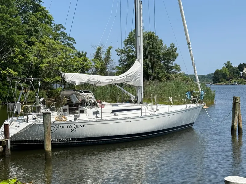 The Image of 1985 Beneteau 42 First sailboat docked on a serene river. - 0