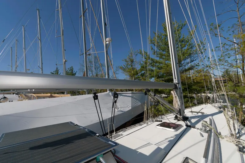 Slide: The Image of 1985 Beneteau 42 First sailboat deck with rigging and mast in a marina. - 15
