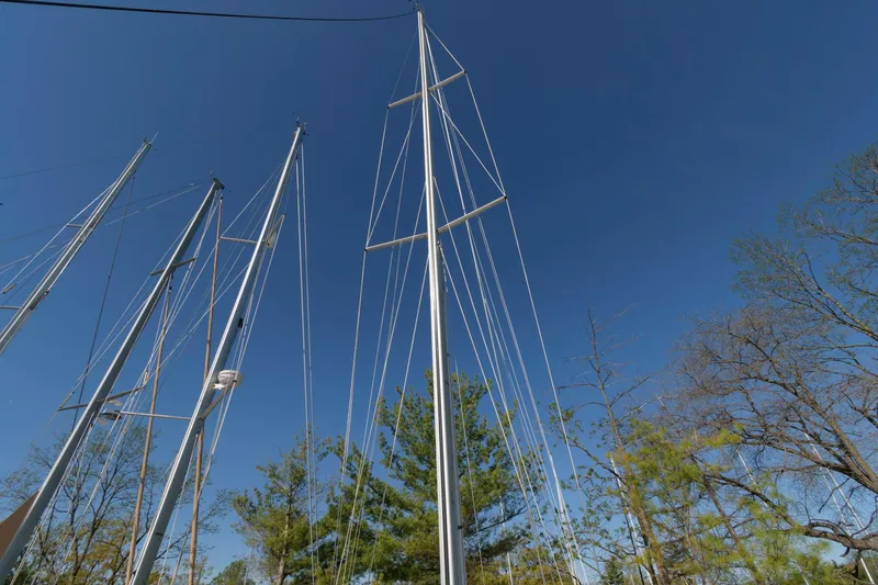 Slide: The Image of Masts of a 1985 Beneteau 42 First sailboat against a clear blue sky. - 16