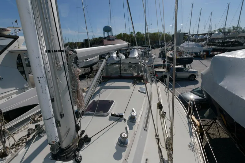 Slide: The Image of 1985 Beneteau 42 First sailboat docked in a marina, view from the deck. - 18