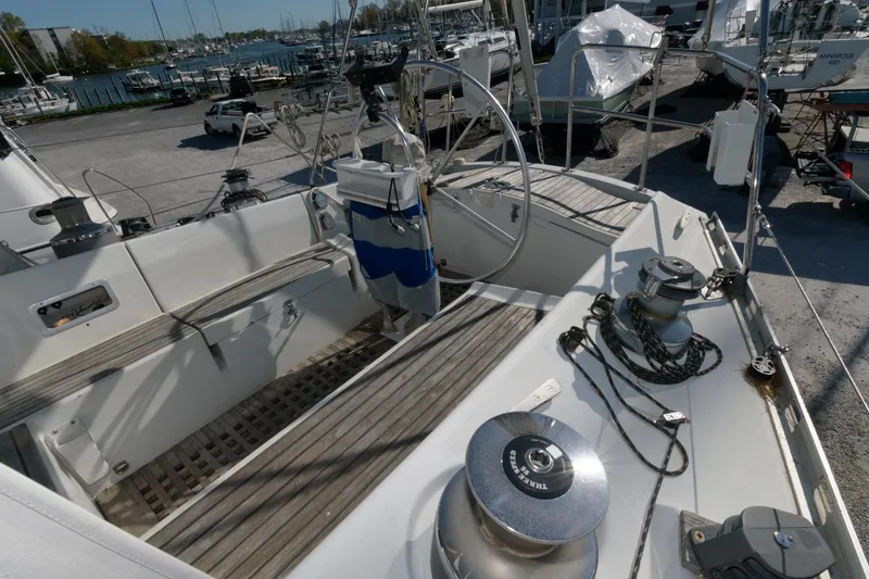 Slide: The Image of Cockpit view of a 1985 Beneteau 42 First sailboat in a marina. - 19