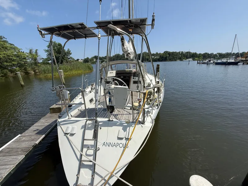 Slide: The Image of 1985 Beneteau 42 First sailboat docked in a serene marina setting. - 2