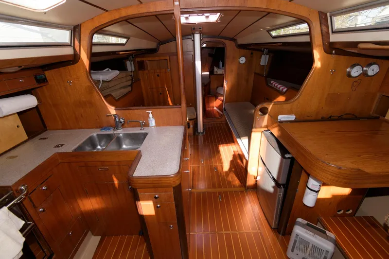 Slide: The Image of Interior of a 1985 Beneteau 42 First sailboat with wooden cabinetry and modern amenities. - 4