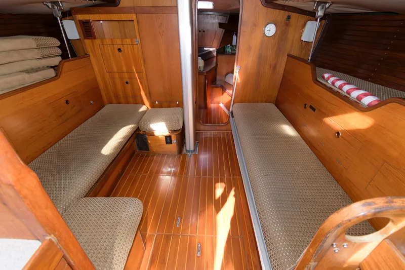 Slide: The Image of Interior of 1985 Beneteau 42 First sailboat with wooden finishes and twin berths. - 6